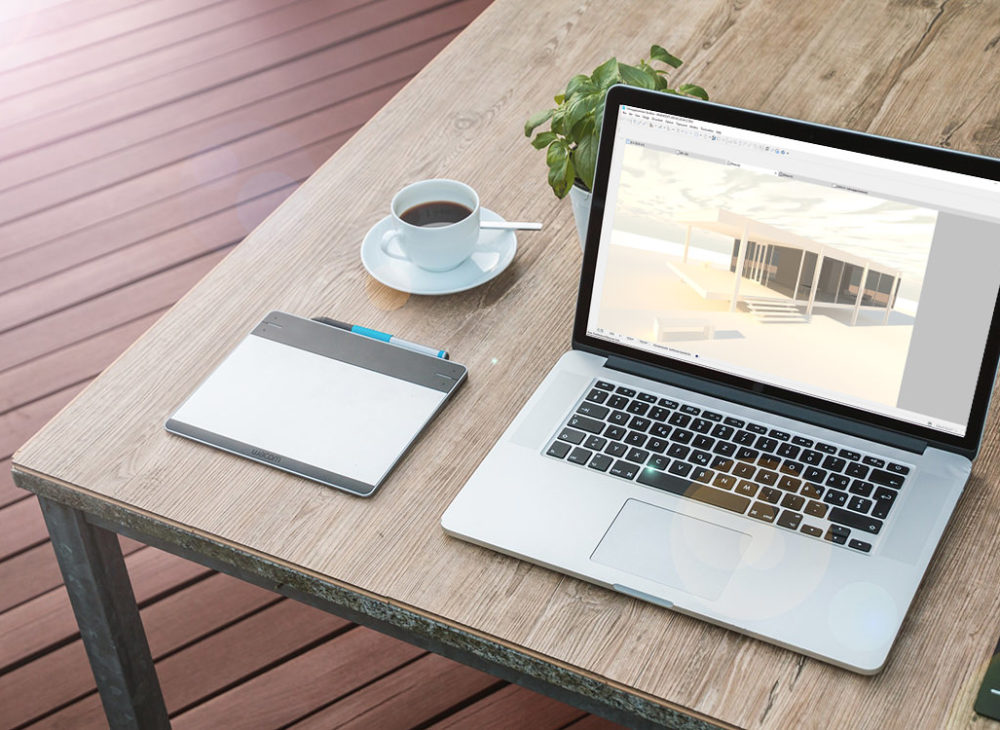 Ein Laptop auf einem Holztisch neben einer Tasse Kaffee, der BIM Basics 2019 präsentiert.