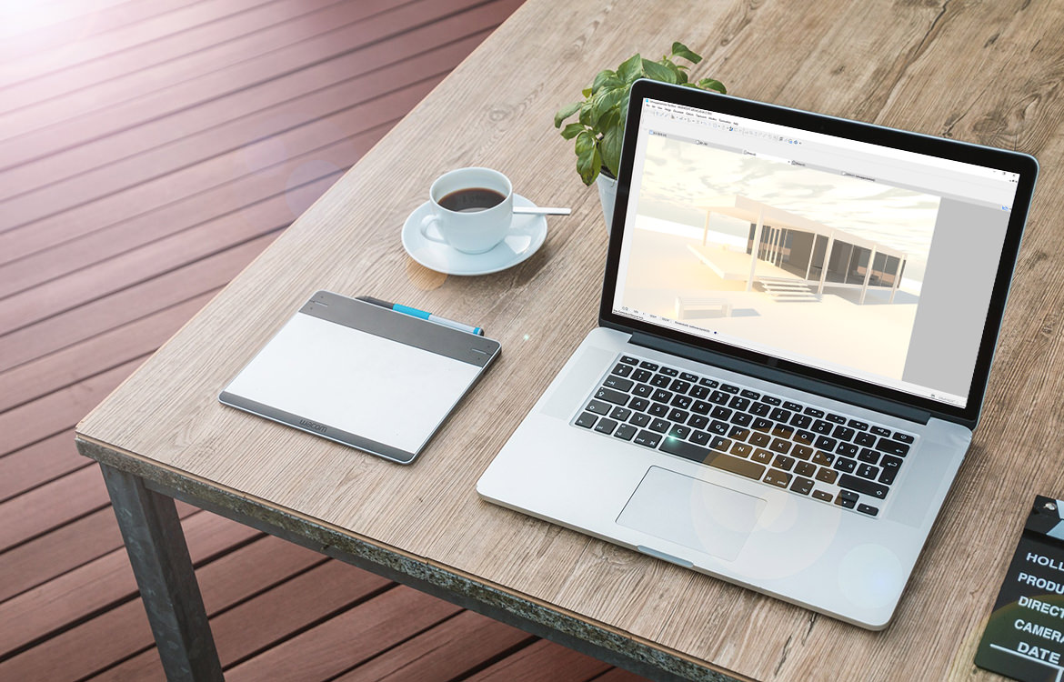 Ein Laptop auf einem Holztisch neben einer Tasse Kaffee, der BIM Basics 2019 präsentiert.